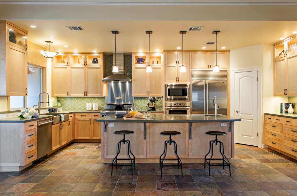Eat-in kitchen - mid-sized transitional l-shaped slate floor eat-in kitchen idea in Austin with an undermount sink, recessed-panel cabinets, light wood cabinets, green backsplash, stainless steel appliances and an island
