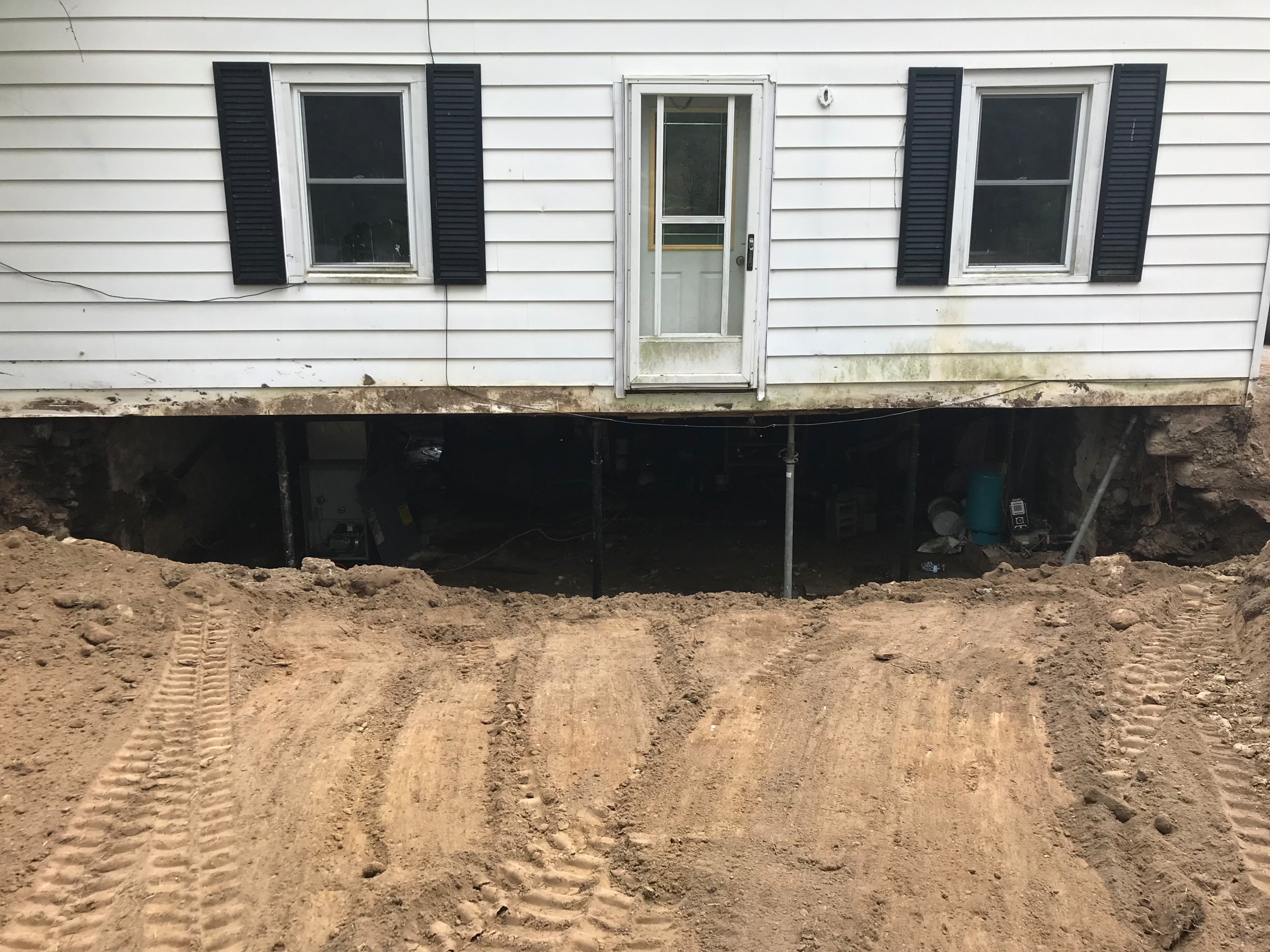 The project involved addressing a failed and settled front foundation wall. Our team lifted and supported the house to safely access the damaged area. We excavated the front section, removed the deter