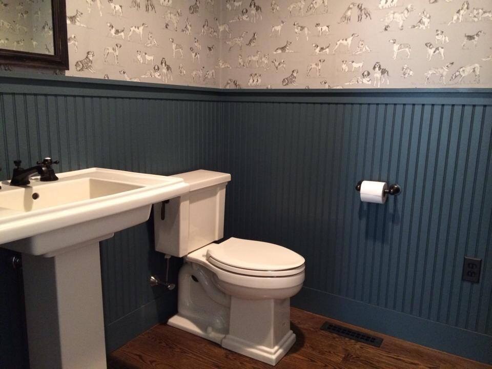 Inspiration for a mid-sized country powder room in Providence with a two-piece toilet, multi-coloured walls, dark hardwood floors, a pedestal sink and brown floor.