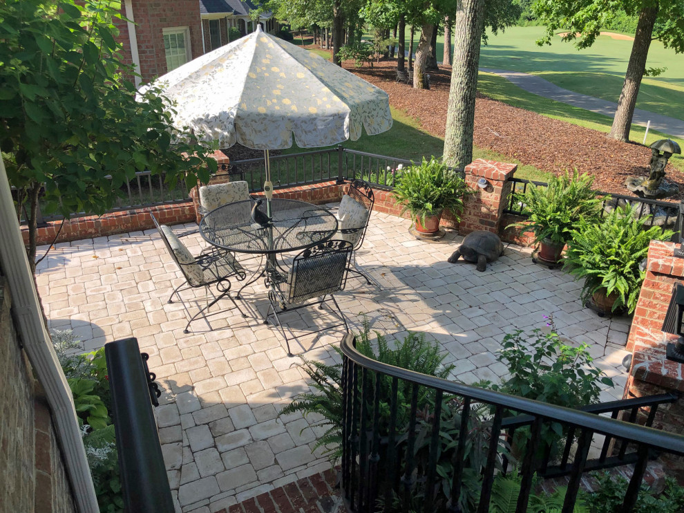 Greensboro Patio Design with Brick Foundation Wall and Custom Railing Traditional Patio