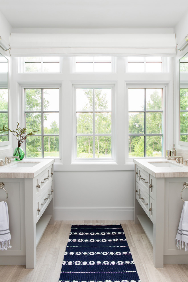 Inspiration for a mid-sized country master bathroom in New York with shaker cabinets, grey cabinets, white walls, an undermount sink, beige floor and beige benchtops.