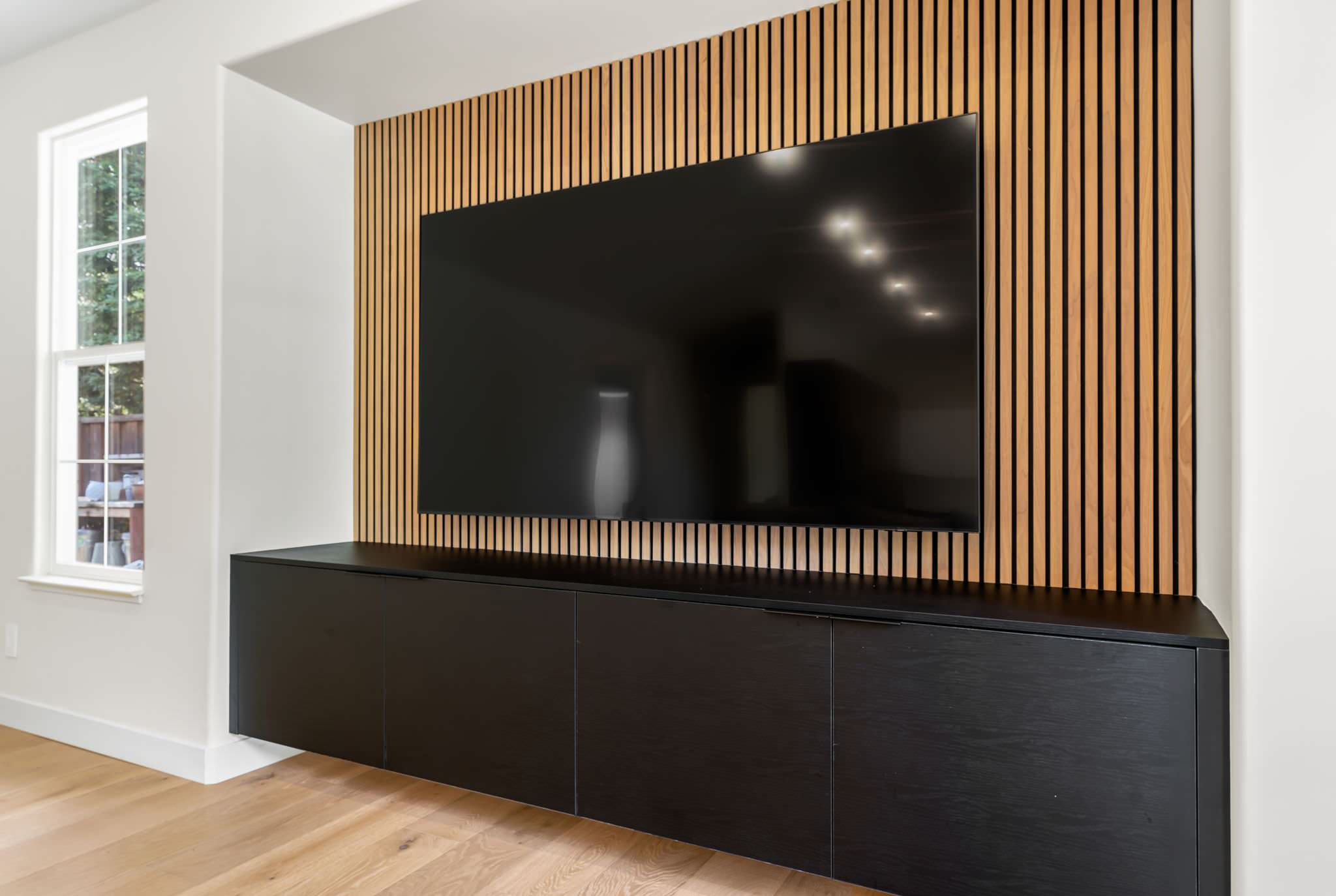 Media wall with paneling and floating media center
