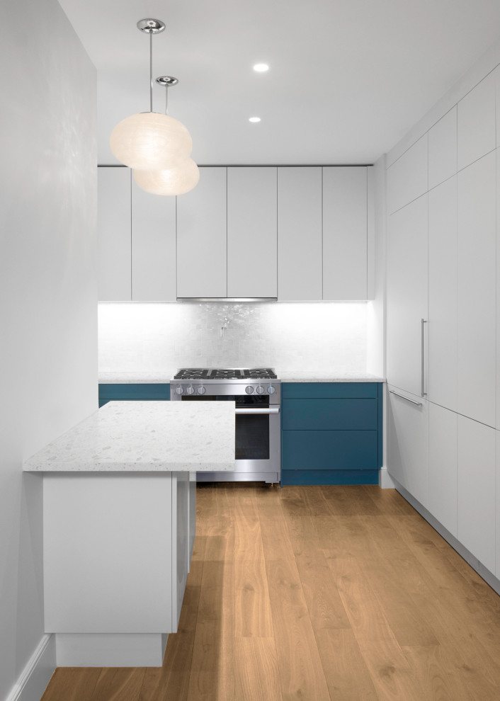 Inspiration for a small contemporary l-shaped separate kitchen in New York with flat-panel cabinets, white cabinets, terrazzo benchtops, white splashback, ceramic splashback, stainless steel appliances, with island and white benchtop.