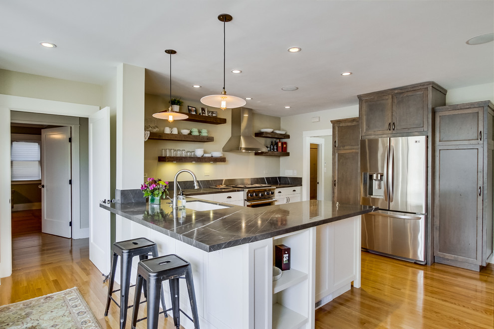 Kitchen - traditional u-shaped kitchen idea in San Diego with recessed-panel cabinets, white cabinets and stainless steel appliances