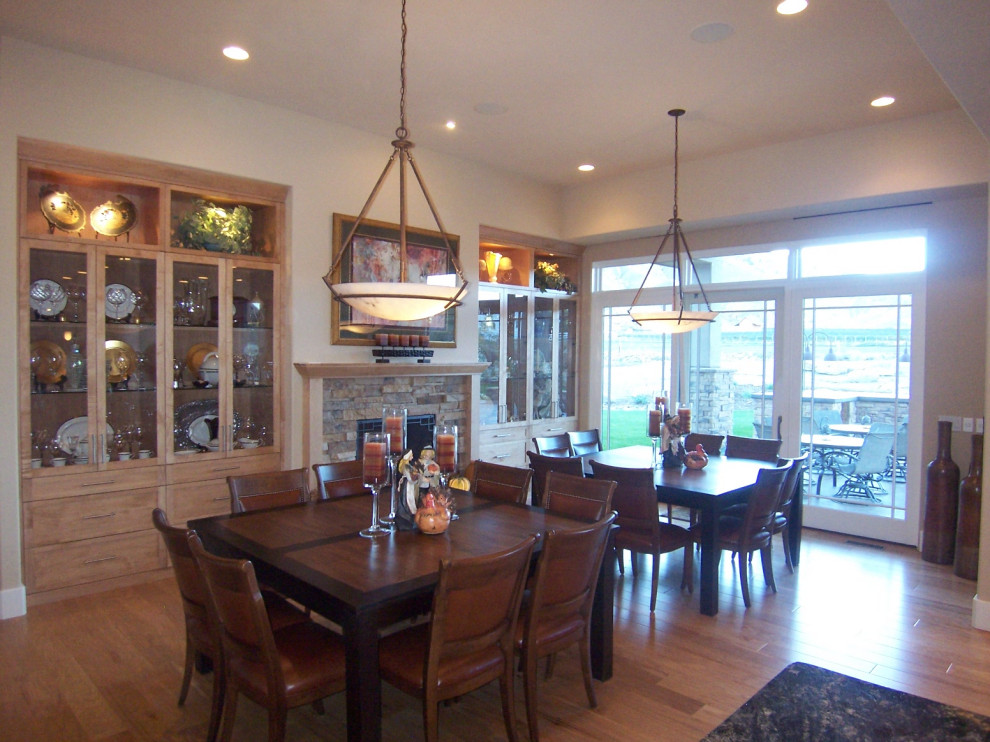 Photo of a large transitional kitchen/dining combo in Denver with light hardwood floors, a standard fireplace, a stone fireplace surround and coffered.