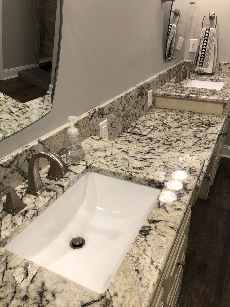 Inspiration for a large traditional master bathroom in Other with raised-panel cabinets, beige cabinets, an alcove shower, grey walls, dark hardwood floors, an undermount sink, granite benchtops, brown floor, a hinged shower door and multi-coloured benchtops.
