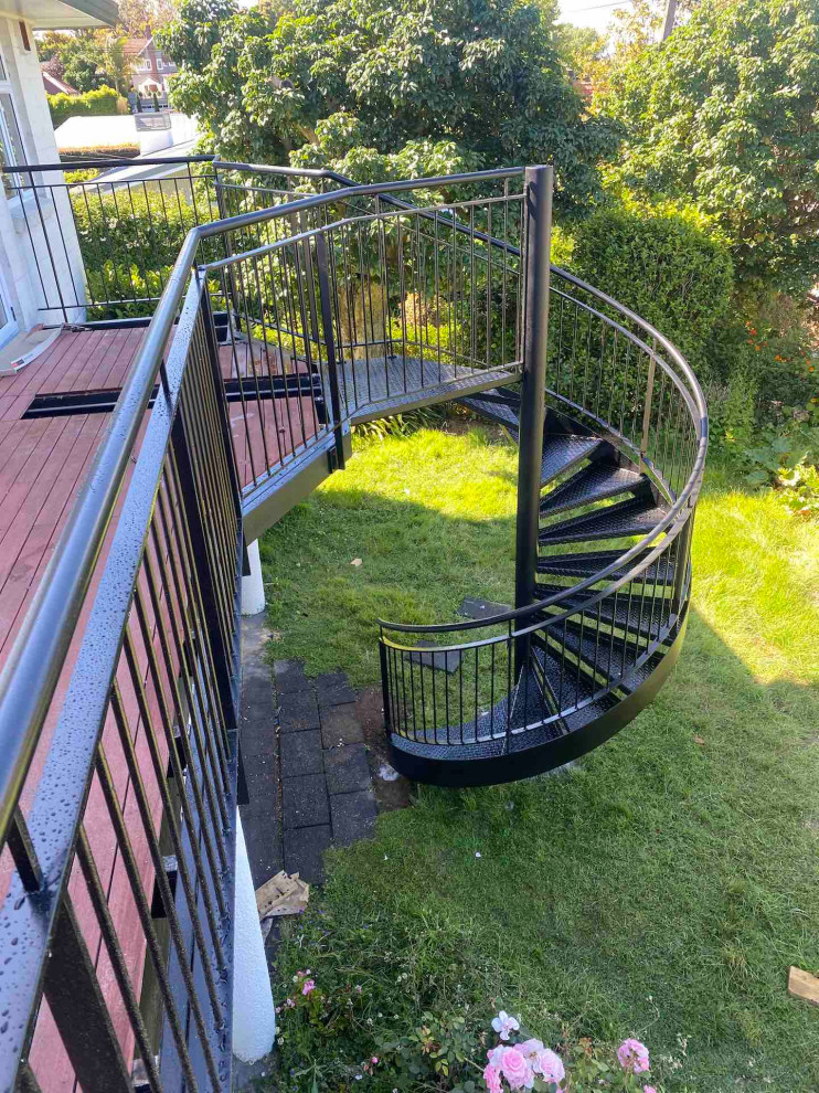 Staircase - mid-sized industrial metal spiral open and metal railing staircase idea in Auckland