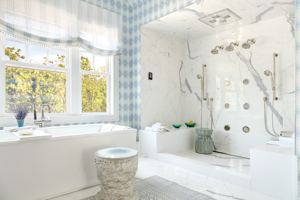 Large beach style master bathroom in New York with a double shower, white tile, porcelain floors, a freestanding tub, stone slab, multi-coloured walls and an open shower.