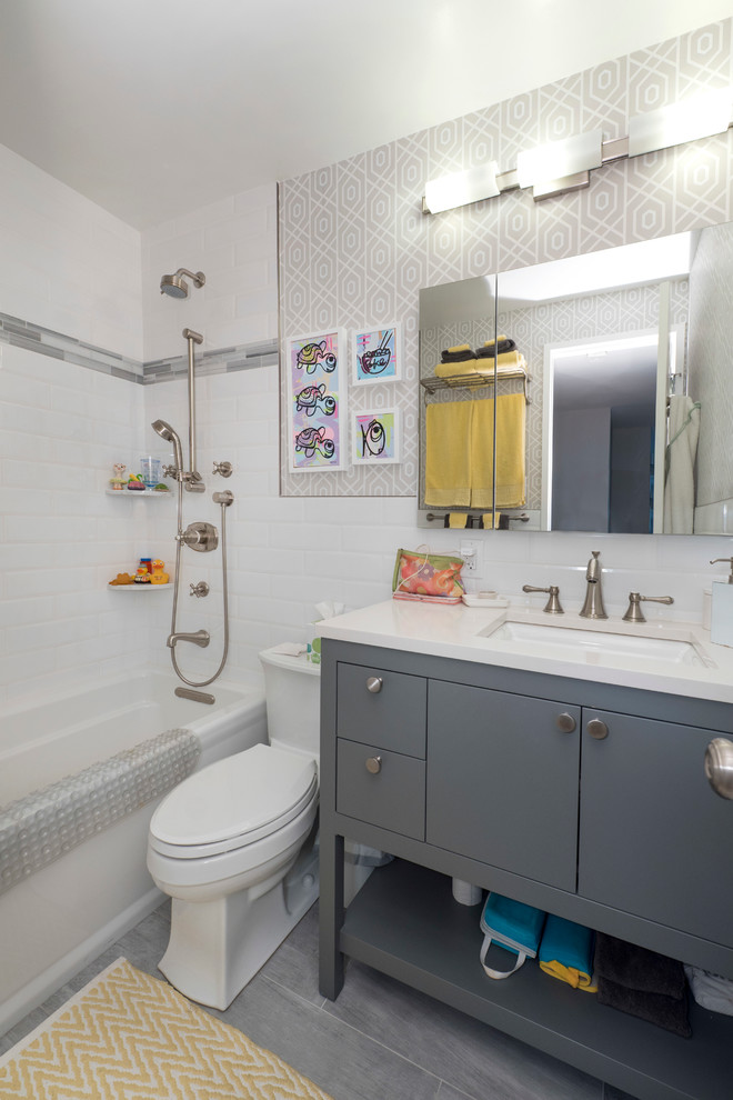 Design ideas for a small modern kids bathroom in New York with flat-panel cabinets, dark wood cabinets, an open shower, a one-piece toilet, stone tile, white walls, marble floors, an undermount sink, marble benchtops and an alcove tub.