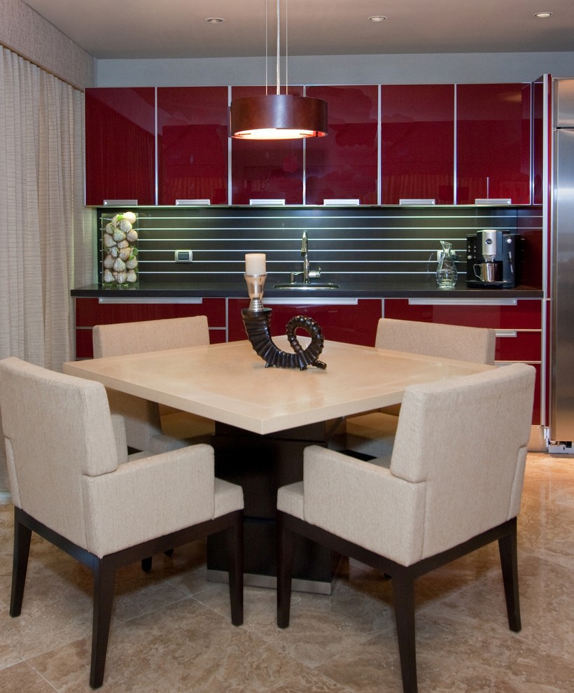 This is an example of a mid-sized contemporary l-shaped open plan kitchen in Other with an undermount sink, red cabinets, stainless steel appliances, glass-front cabinets, quartz benchtops, brown splashback, marble floors, stone slab splashback, a peninsula, beige floor and brown benchtop.
