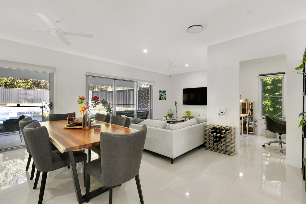 Design ideas for a contemporary open concept living room in Brisbane with white walls, porcelain floors and beige floor.