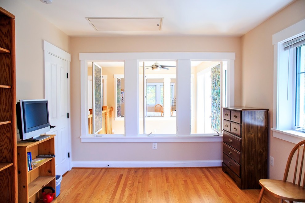 Mid-sized country guest bedroom in DC Metro with beige walls, medium hardwood floors and no fireplace.