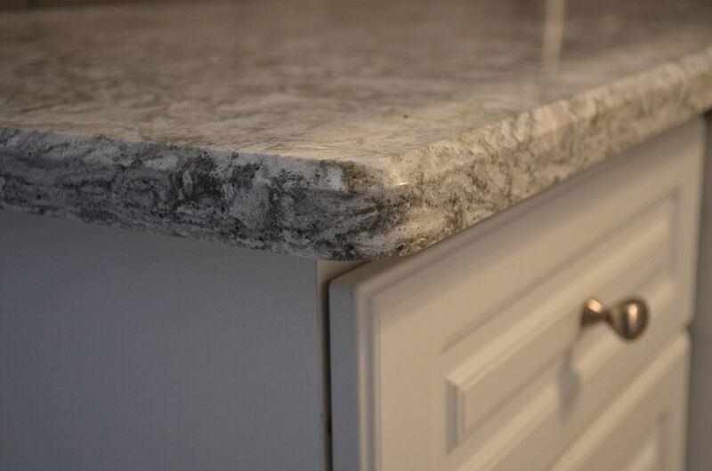 Mid-sized transitional u-shaped vinyl floor open concept kitchen photo in Toronto with an undermount sink, raised-panel cabinets, white cabinets, quartzite countertops, gray backsplash, glass tile backsplash, white appliances and a peninsula