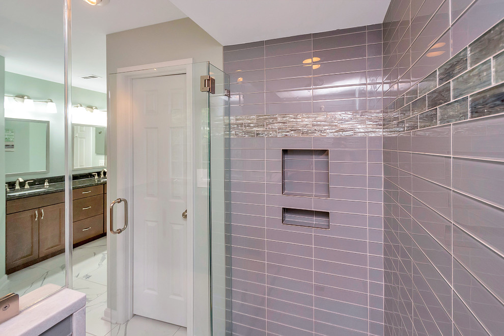 Design ideas for a large transitional master bathroom in DC Metro with raised-panel cabinets, medium wood cabinets, an alcove shower, blue tile, glass tile, grey walls, marble floors, an undermount sink, granite benchtops, white floor and a hinged shower door.