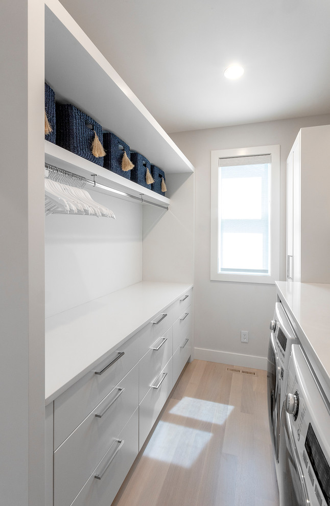 Design ideas for a mid-sized contemporary galley utility room in Boston with flat-panel cabinets.