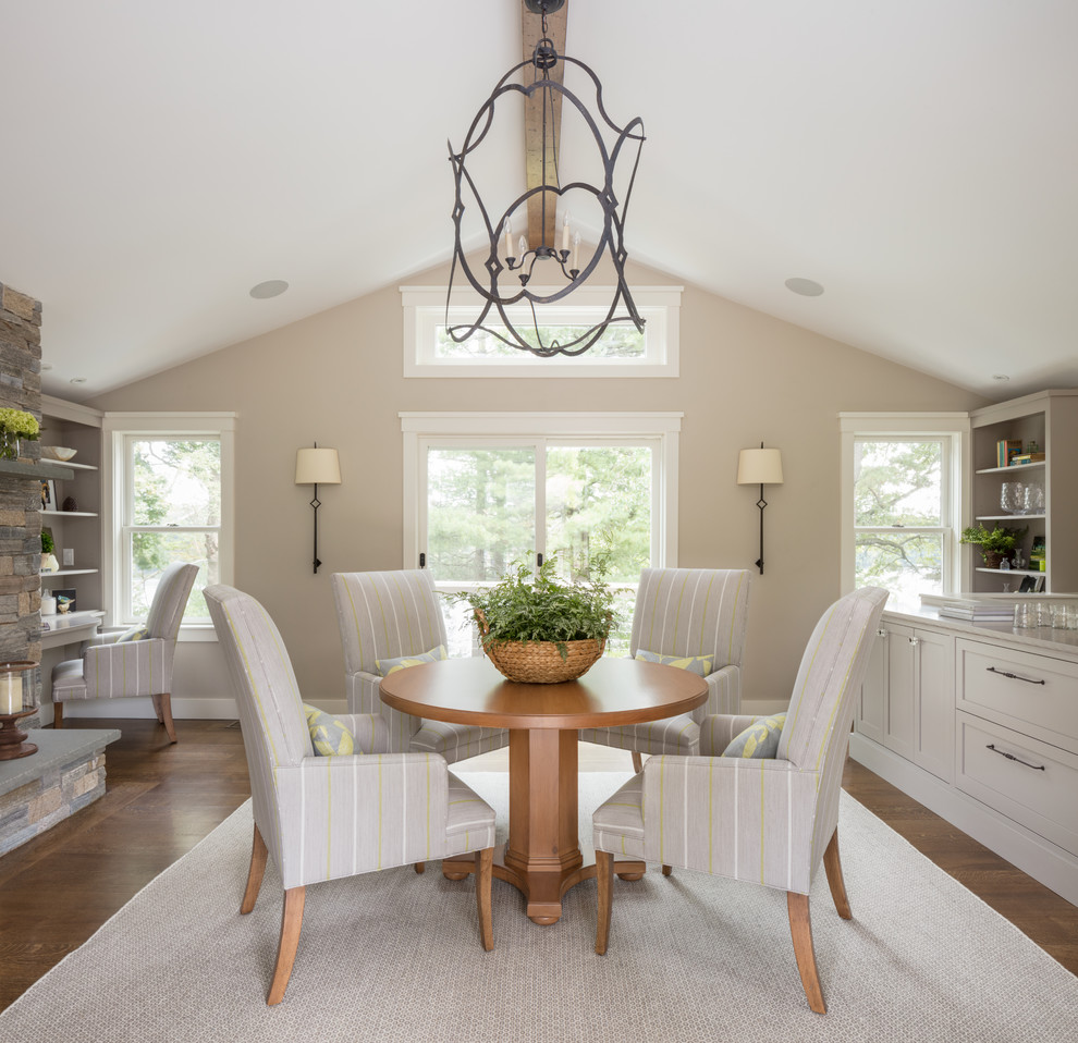 Inspiration for a mid-sized transitional separate dining room in Boston with beige walls, a standard fireplace, a stone fireplace surround, beige floor and dark hardwood floors.