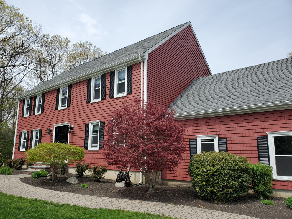 Photo of a red traditional two floor detached house in Boston with vinyl cladding.
