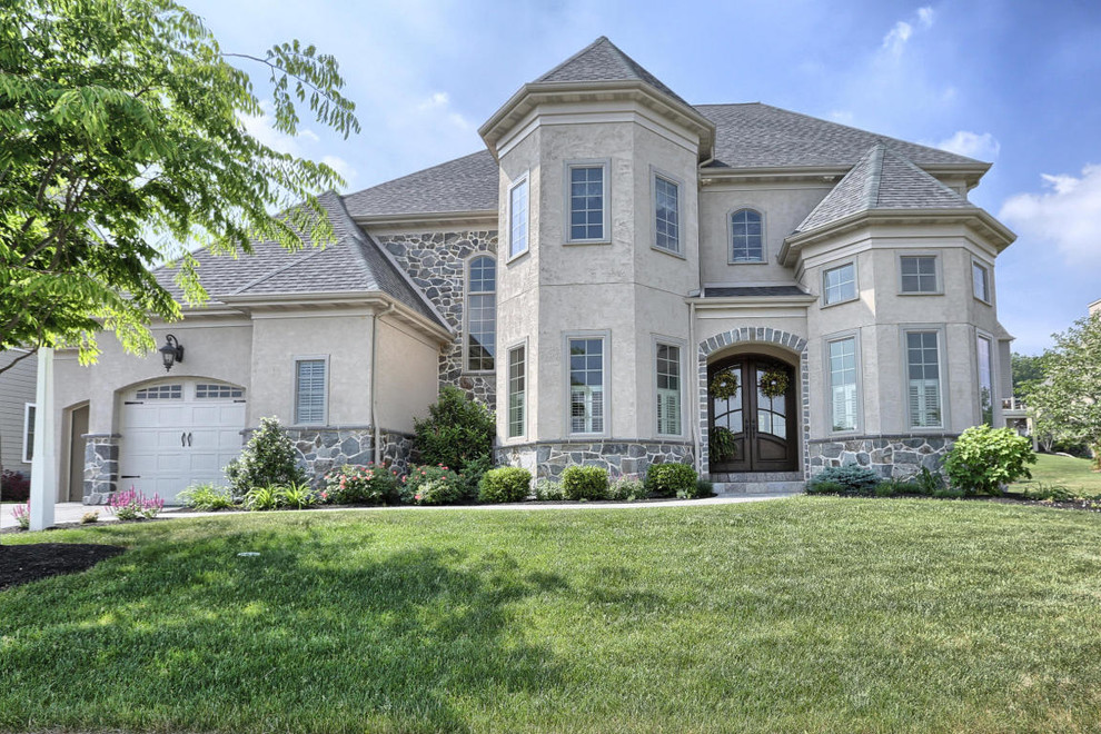 Example of a mid-sized transitional gray two-story mixed siding house exterior design with a hip roof and a shingle roof