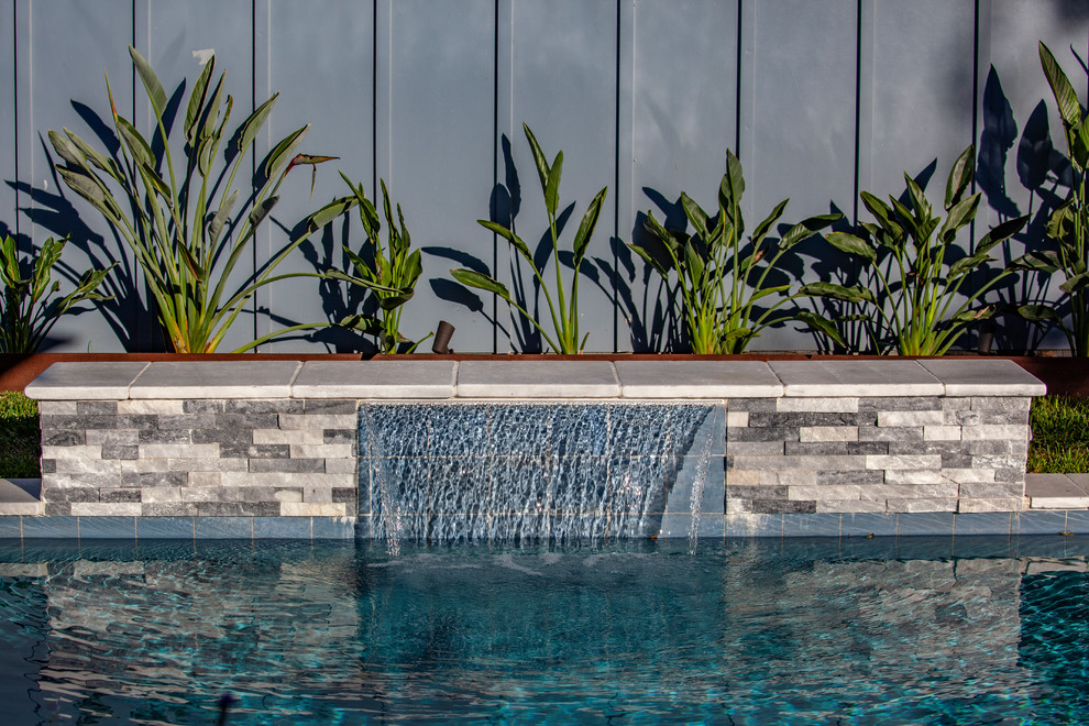 Mid-sized modern backyard rectangular pool in Houston.