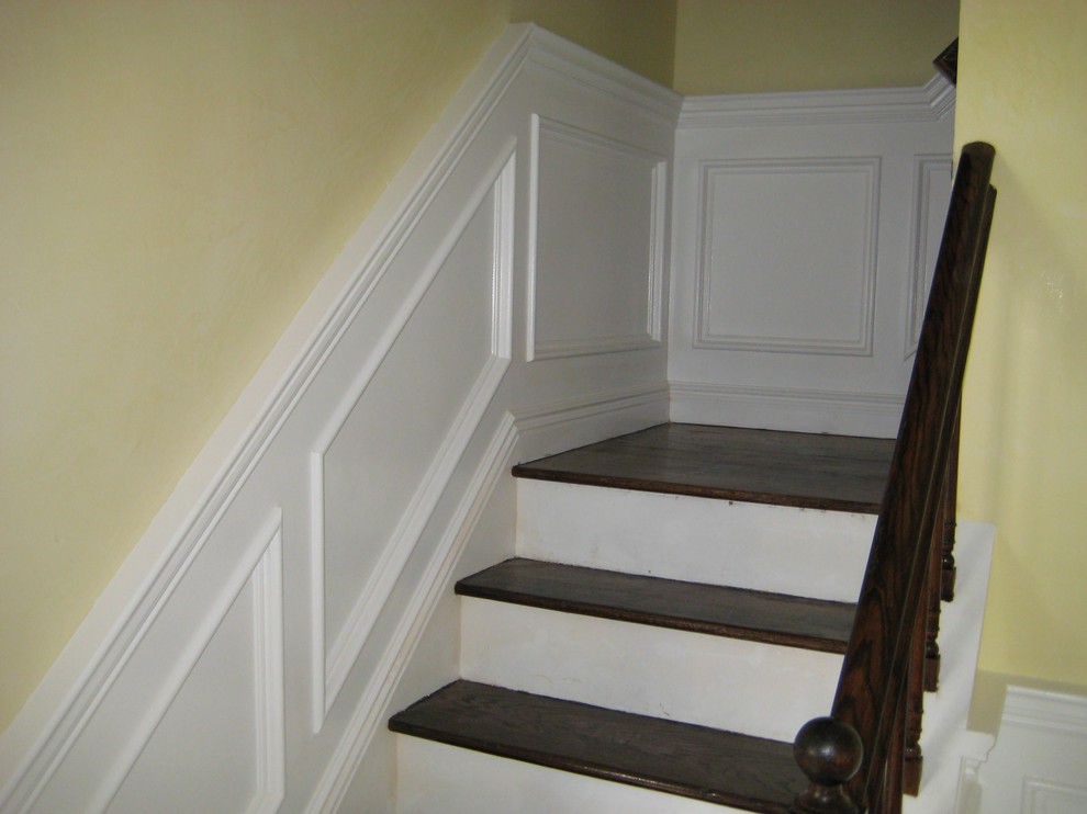 Inspiration for a mid-sized traditional wood straight staircase in New York with painted wood risers and wood railing.