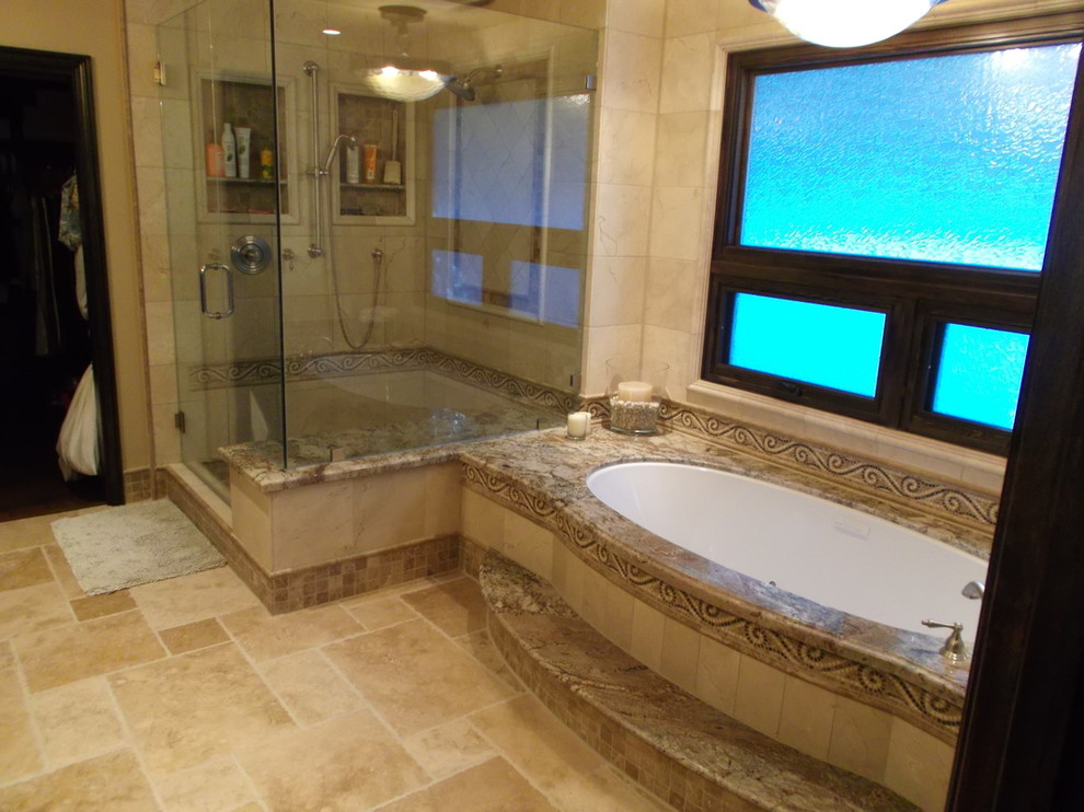 This is an example of a mid-sized traditional master bathroom in San Diego with an undermount tub, a corner shower, beige walls, limestone floors, beige floor, a hinged shower door, white tile, marble, granite benchtops and multi-coloured benchtops.