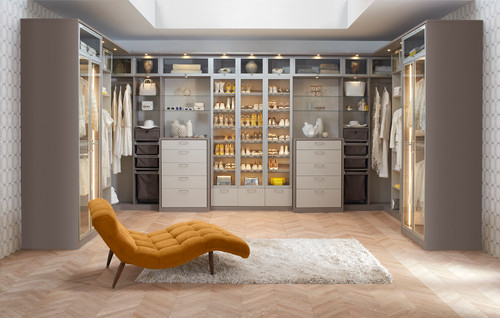 Modern style walk-in closet with lighted shoe storage.