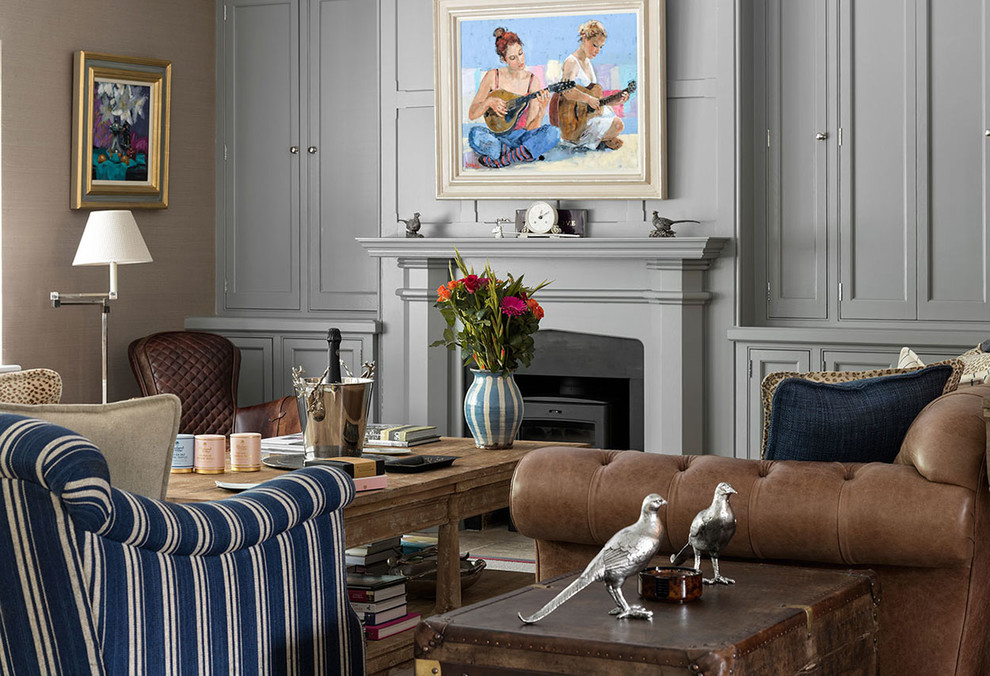Medium sized classic formal enclosed living room in Hampshire with grey walls, a wood burning stove, a plastered fireplace surround, no tv and carpet.
