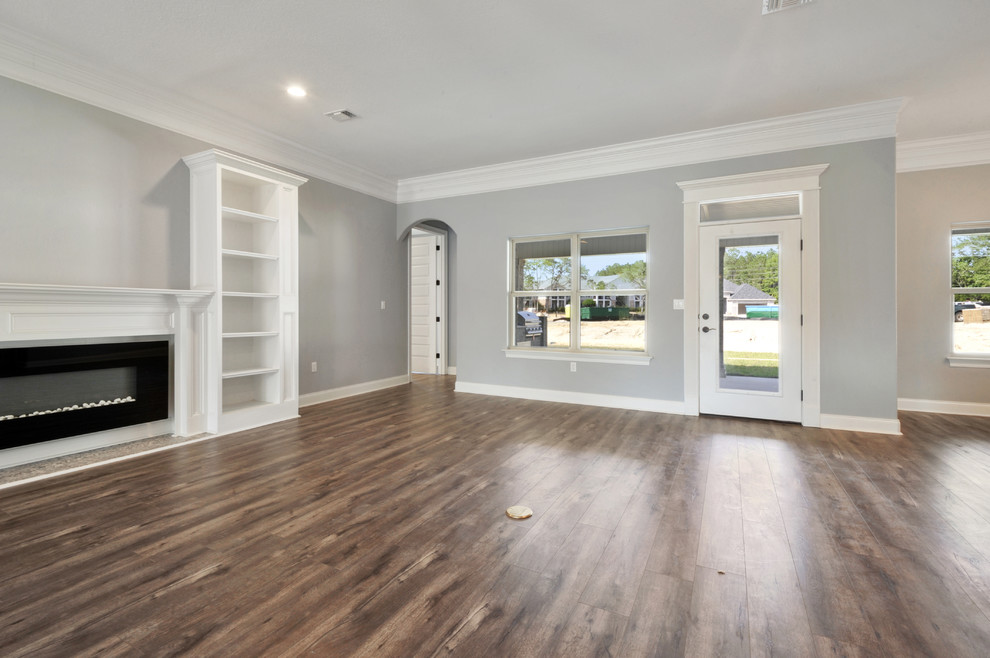 Traditional open concept family room in Other with laminate floors.
