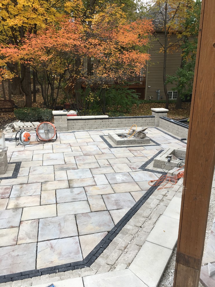 Photo of a large modern backyard garden in Chicago with brick pavers.