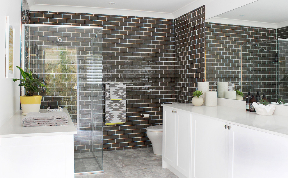 Mid-sized beach style master bathroom in Sydney with shaker cabinets, white cabinets, a two-piece toilet, brown tile, subway tile, ceramic floors, an undermount sink, multi-coloured floor and a hinged shower door.