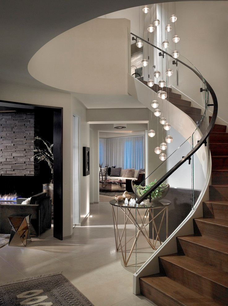 Staircase - contemporary wooden curved staircase idea in Chicago with wooden risers