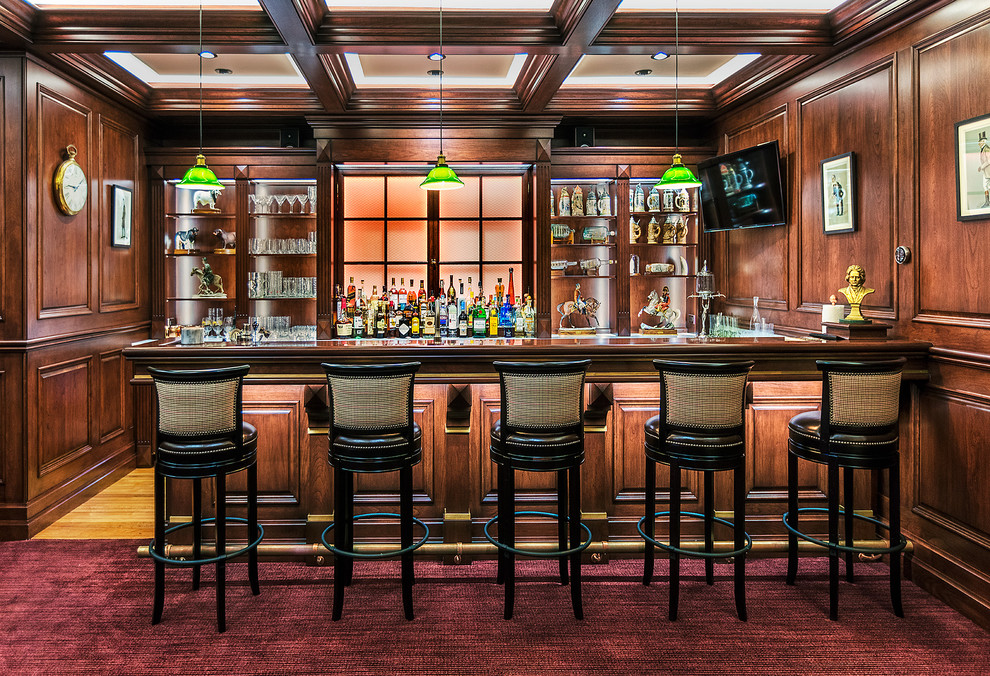 Photo of a large traditional seated home bar in Denver with granite benchtops, timber splashback, open cabinets, dark wood cabinets, carpet and red floor.