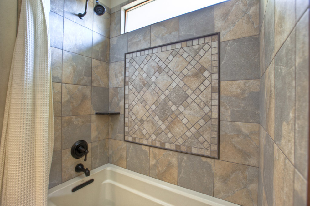 Country bathroom in Houston with a drop-in tub, brown tile and ceramic tile.