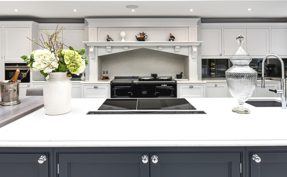 Inspiration for a large l-shaped eat-in kitchen in Berkshire with a drop-in sink, shaker cabinets, grey cabinets, granite benchtops, grey splashback, mirror splashback, panelled appliances, with island and white benchtop.