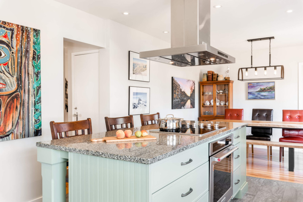Example of a mid-sized transitional galley eat-in kitchen design with shaker cabinets and an island