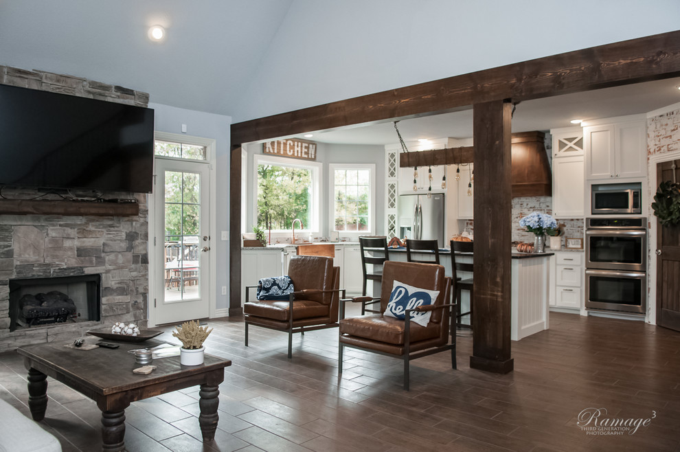 Open concept kitchen - large transitional u-shaped brown floor open concept kitchen idea with a farmhouse sink, shaker cabinets, white cabinets, granite countertops, multicolored backsplash, brick backsplash, stainless steel appliances, an island and gray countertops