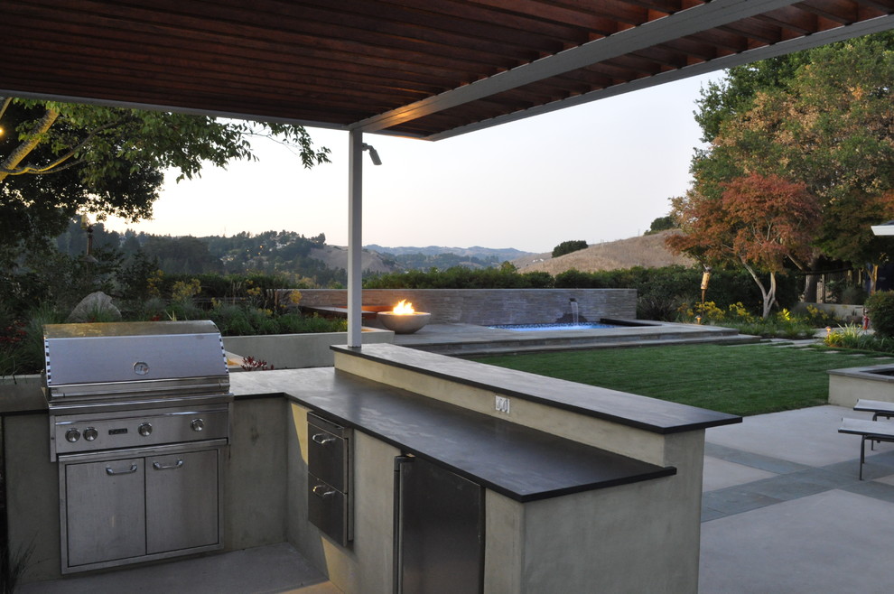 Photo of a contemporary patio in San Francisco with a fire feature and a pergola.