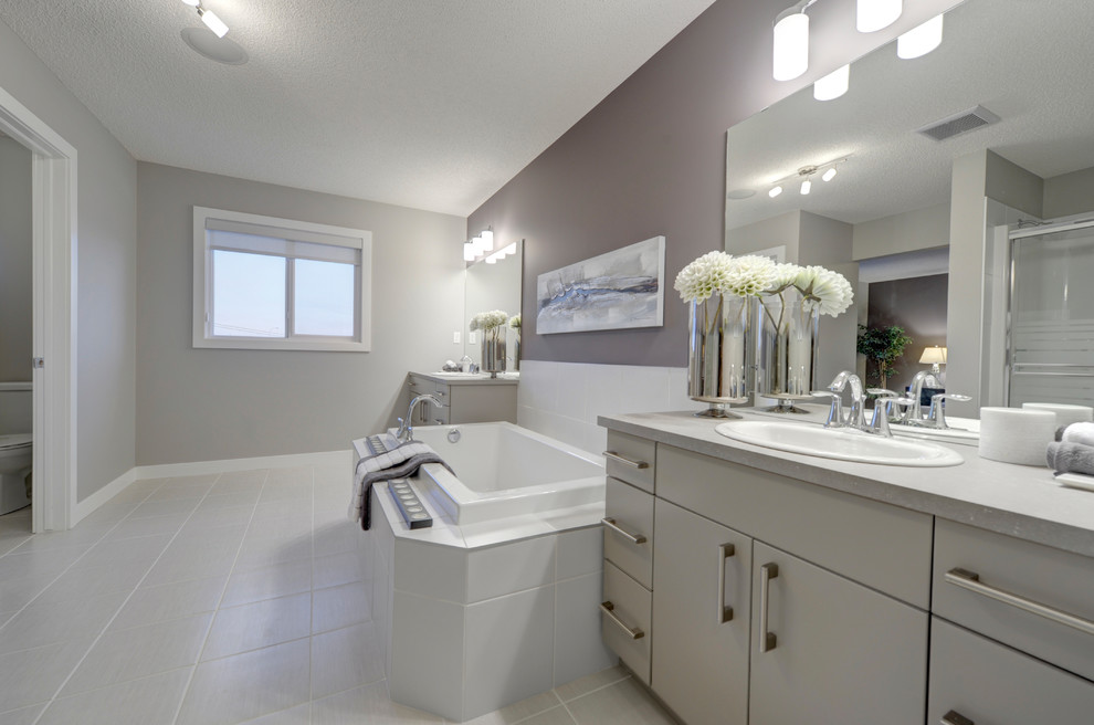 Large transitional master bathroom in Edmonton with a drop-in sink, flat-panel cabinets, white cabinets, laminate benchtops, an alcove tub, an alcove shower, a one-piece toilet, gray tile, ceramic tile, purple walls and ceramic floors.