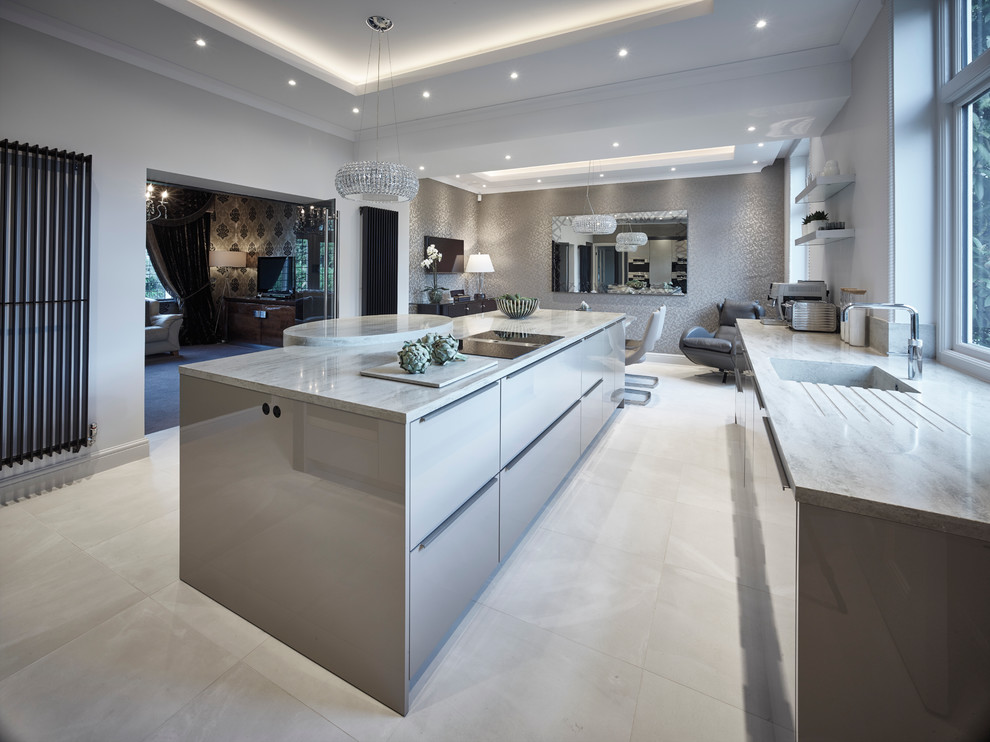Photo of a large contemporary l-shaped eat-in kitchen in Other with a drop-in sink, flat-panel cabinets, beige cabinets, solid surface benchtops, stainless steel appliances, porcelain floors, with island, beige floor and beige benchtop.
