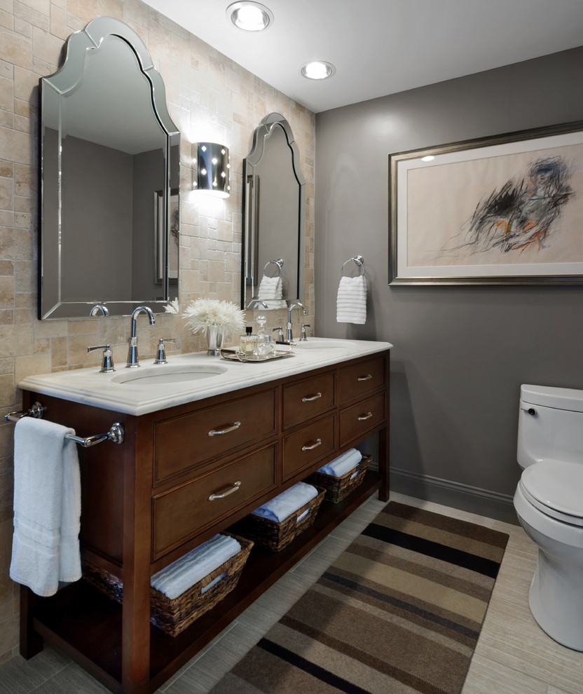 Inspiration for a transitional beige tile bathroom remodel in Chicago with an undermount sink, dark wood cabinets and beaded inset cabinets