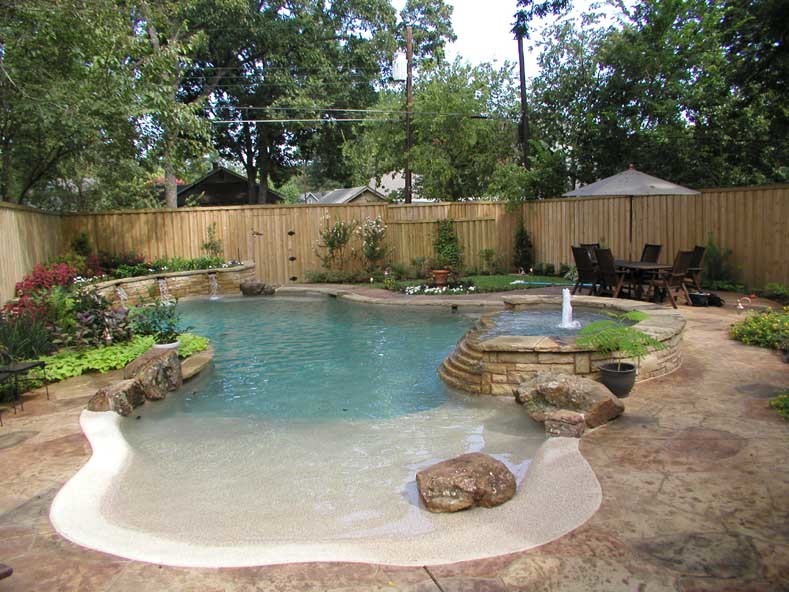 Inspiration for a mid-sized traditional backyard custom-shaped pool in Dallas with a hot tub and stamped concrete.