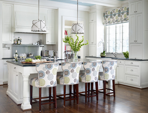 Modern style kitchen featuring a round floral style print on the bar stools and curtains