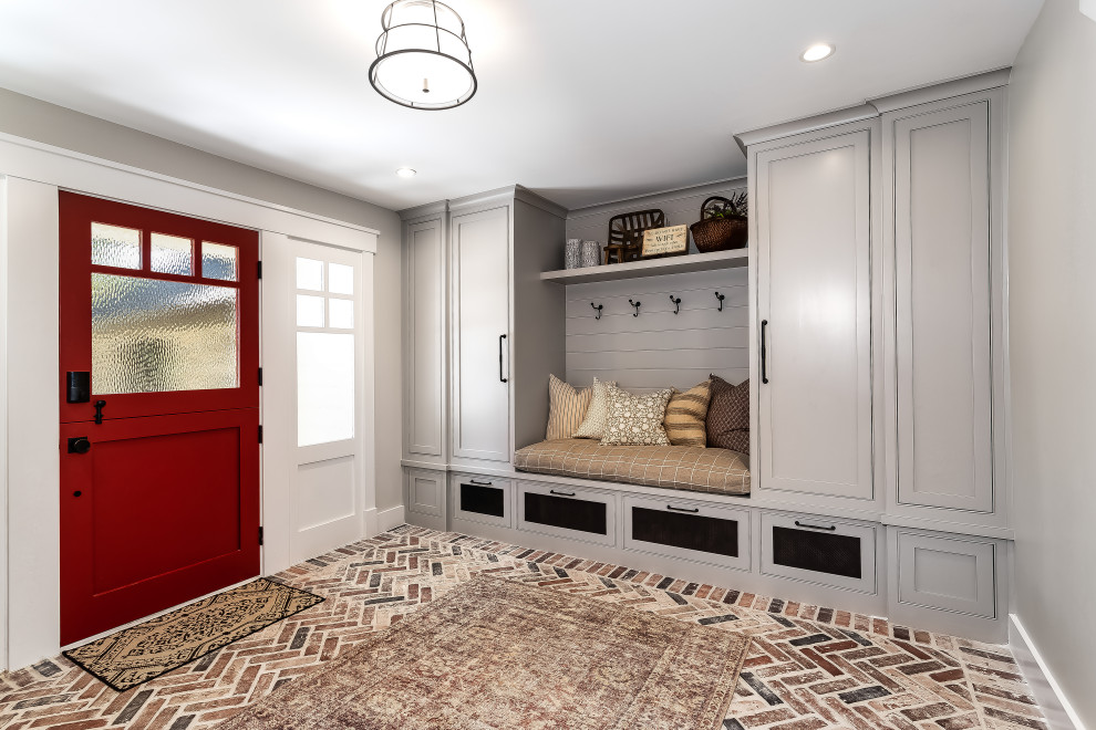Country boot room in Los Angeles with grey walls, brick flooring, a stable front door, a red front door, multi-coloured floors and tongue and groove walls.