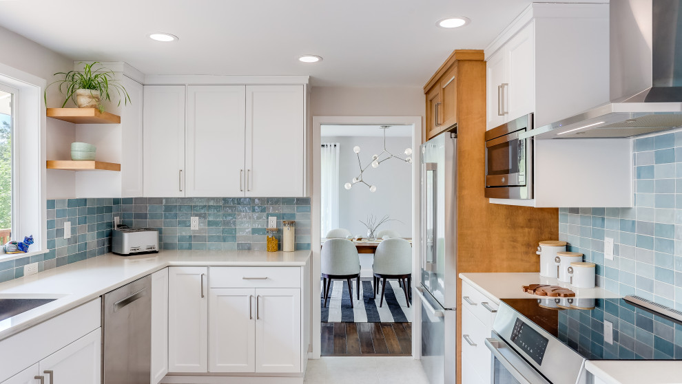Design ideas for a mid-sized midcentury u-shaped eat-in kitchen in Seattle with an undermount sink, recessed-panel cabinets, white cabinets, quartz benchtops, blue splashback, porcelain splashback, stainless steel appliances, ceramic floors, a peninsula, beige floor and beige benchtop.