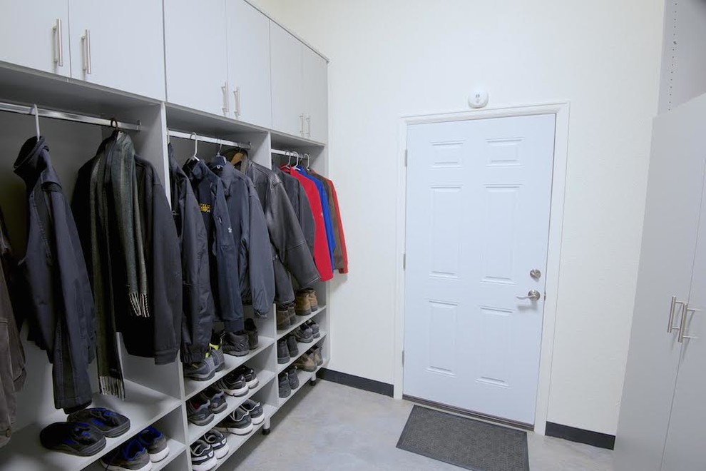 This is an example of a small modern mudroom in Los Angeles with white walls, a white front door, linoleum floors and a single front door.