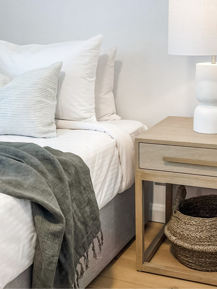 Mid-sized contemporary guest bedroom in Sunshine Coast with white walls and light hardwood floors.