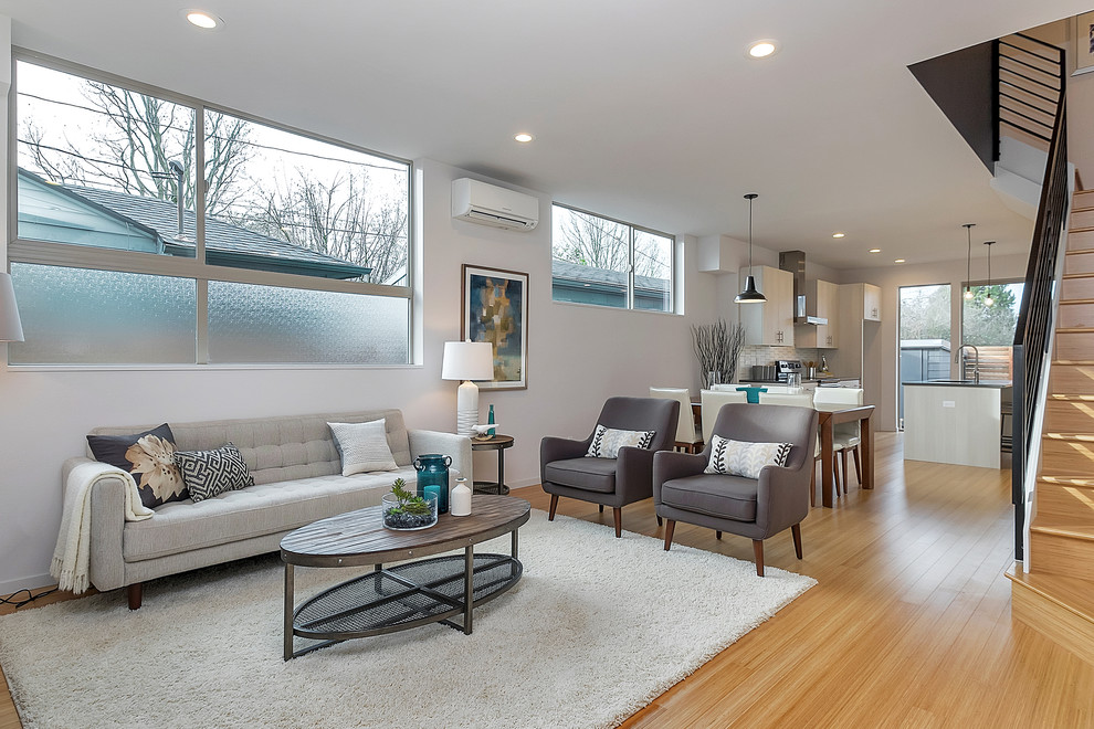 This is an example of a mid-sized transitional formal open concept living room in Portland with white walls.