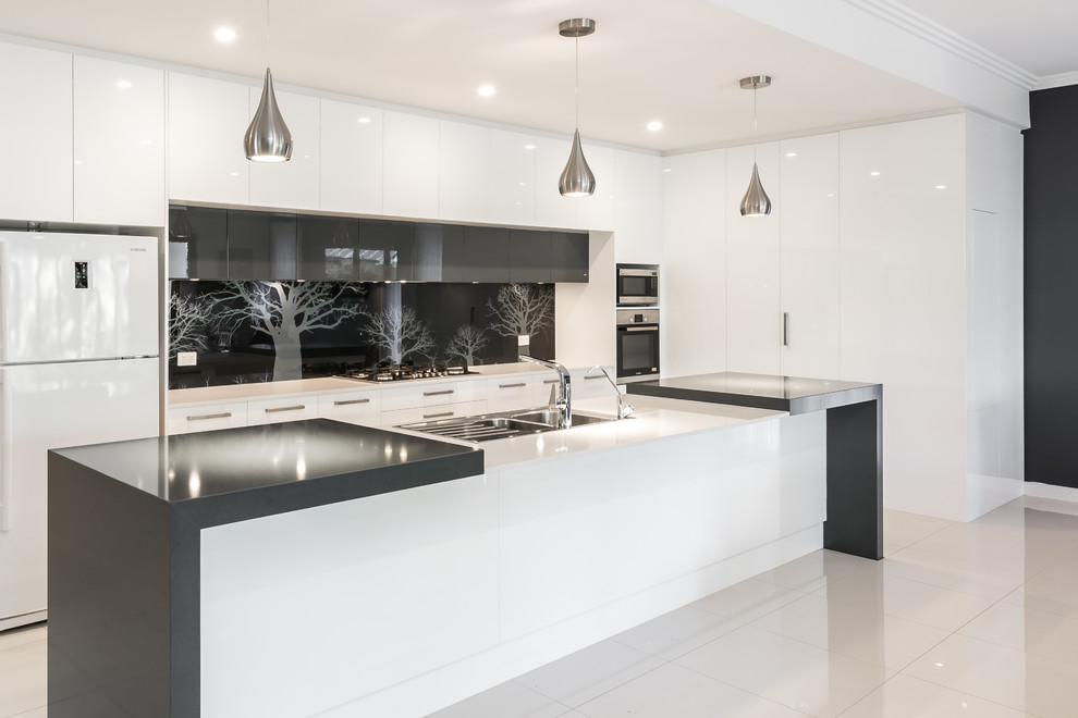 Design ideas for a mid-sized contemporary l-shaped kitchen pantry in Adelaide with a double-bowl sink, flat-panel cabinets, white cabinets, quartz benchtops, black splashback, glass sheet splashback, stainless steel appliances, ceramic floors and with island.