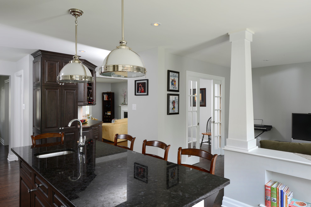 Transitional dark wood floor eat-in kitchen photo in Ottawa with a single-bowl sink, raised-panel cabinets, white cabinets, granite countertops, gray backsplash, ceramic backsplash, stainless steel appliances and an island