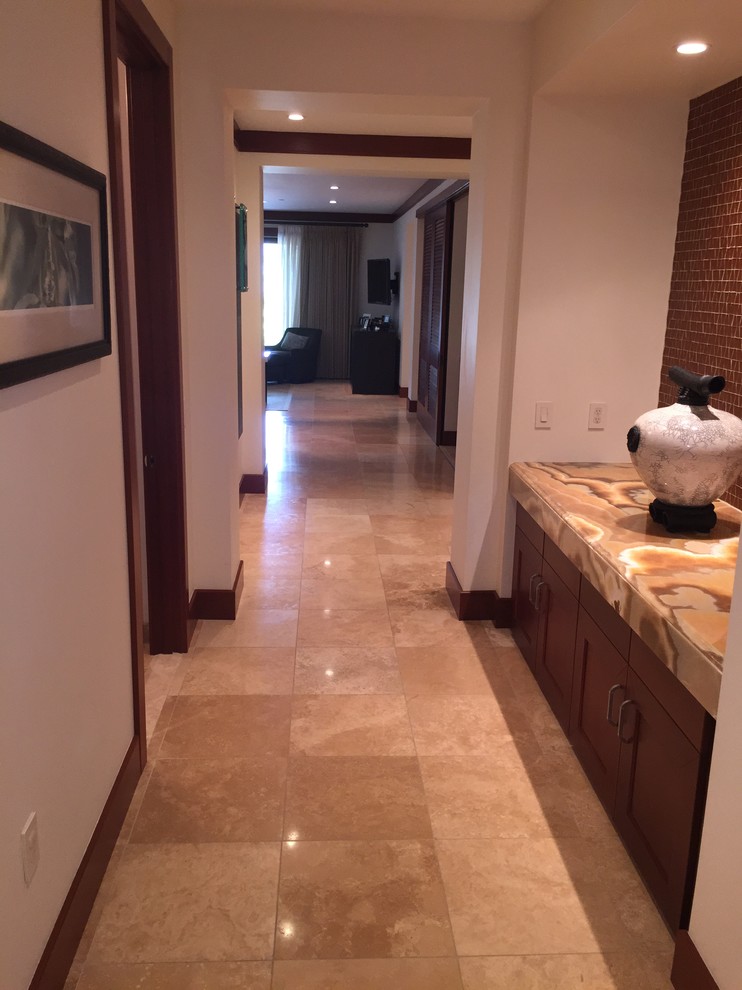 Large island style limestone floor hallway photo in Other with white walls